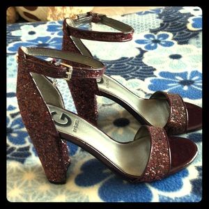 Guess open-toe design and buckled ankle strap.